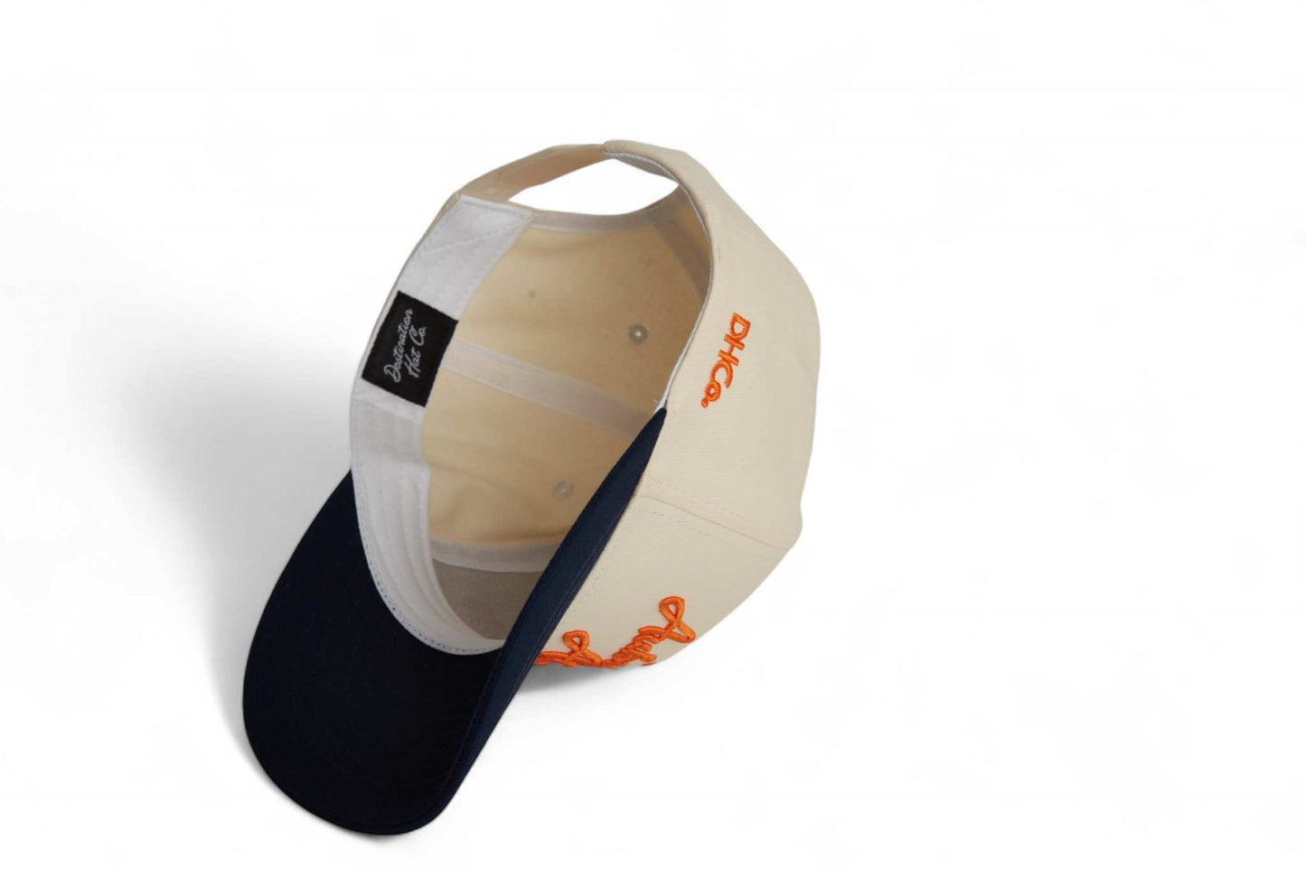 Auburn Script Hat in beige and navy cotton with orange script embroidery and a pre-curved brim