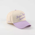 Trucker hat in beige and purple with embroidered Baton Rouge Louisiana script and pre-curved brim, Callin’ Baton Rouge!