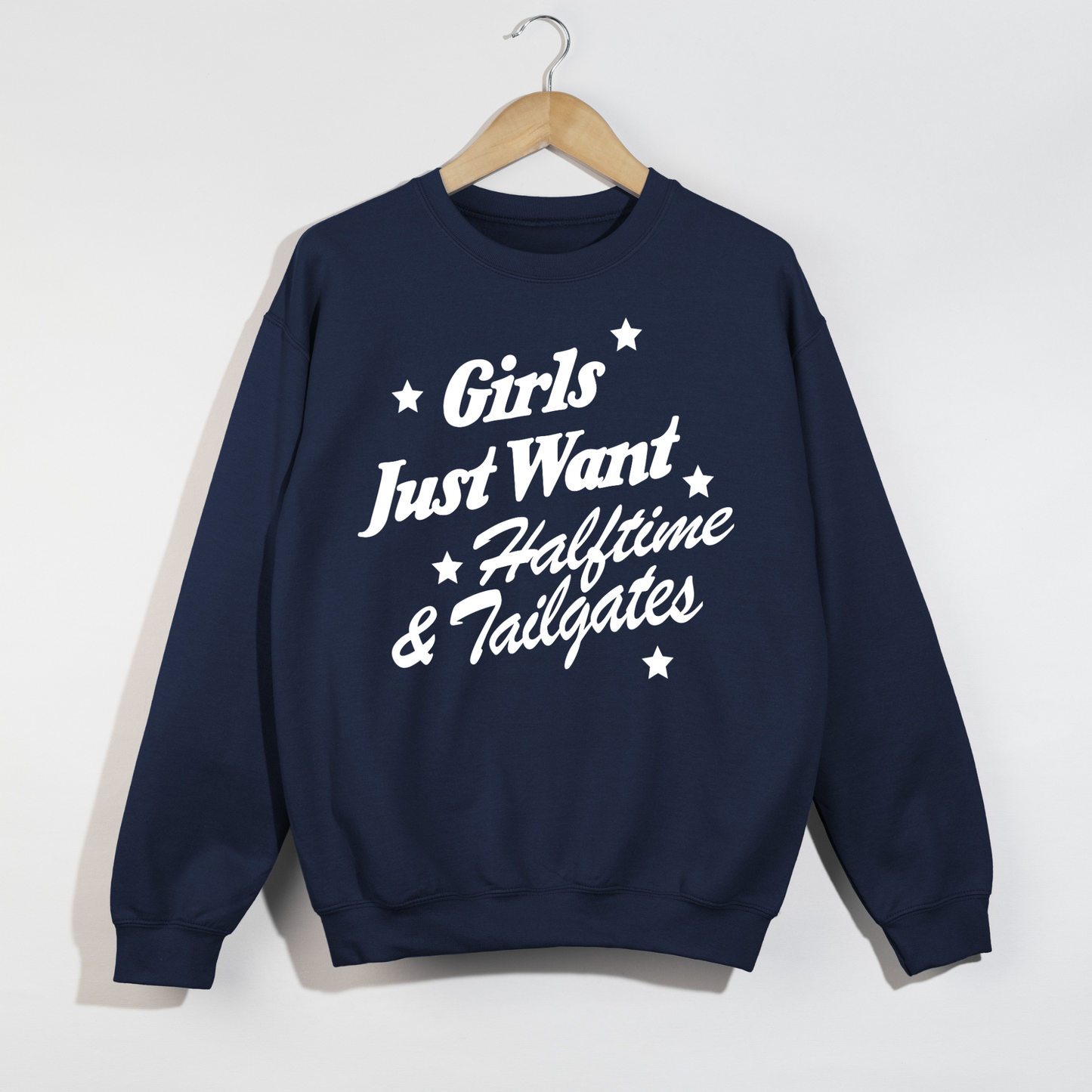 Girls Just Want navy crewneck sweatshirt with white script football graphic, stars, and ribbed cuffs