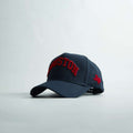 Houston Legacy Snapback in dark navy with red embroidery, curved brim, and red Texas side patch