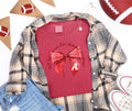 Crimson watercolor game-day bow graphic on a Comfort Colors T-shirt