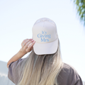 Mrs Trucker Hat in white foam-front mesh trucker style with blue “It’s Giving Mrs” lettering and snapback closure