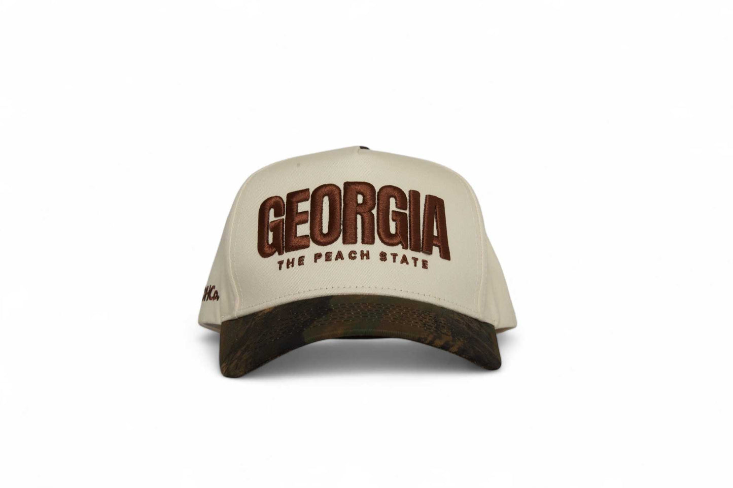 The Camo Georgia Snapback beige trucker hat with brown camouflage brim and embroidered Georgia peach state lettering