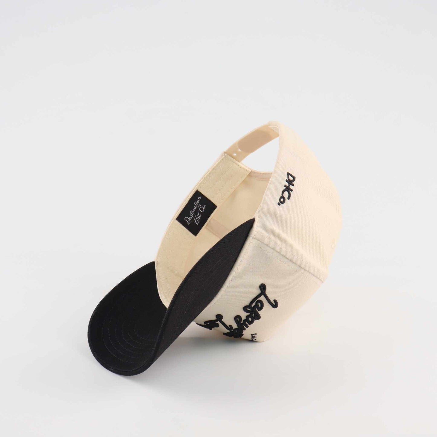 The Lafayette Script Hat, beige and black cotton trucker cap with embroidered script and pre-curved brim