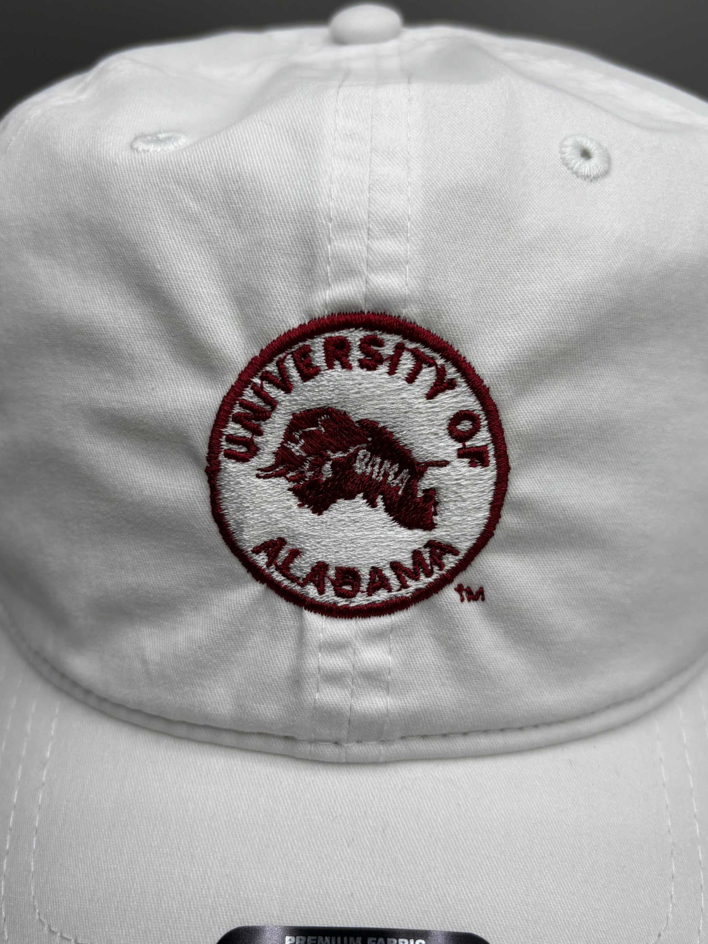 University of Alabama white cotton unstructured hat with embroidered crimson circular logo and adjustable strapback