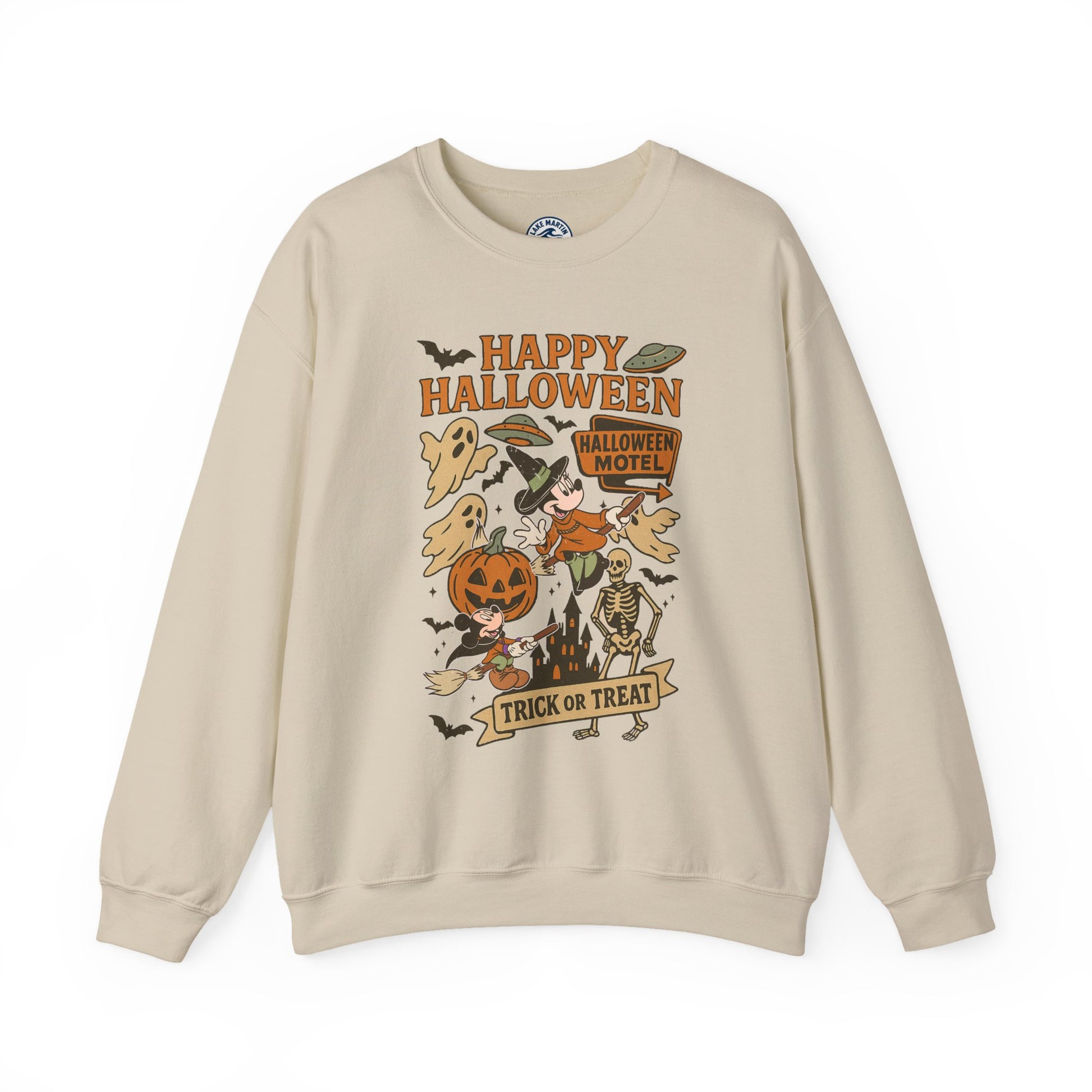 A beige crewneck sweatshirt featuring a colorful retro Halloween graphic on the front with the text 'Happy Halloween' and 'Trick or Treat' along with illustrations of a pumpkin, ghosts, a skeleton, and a motel sign.