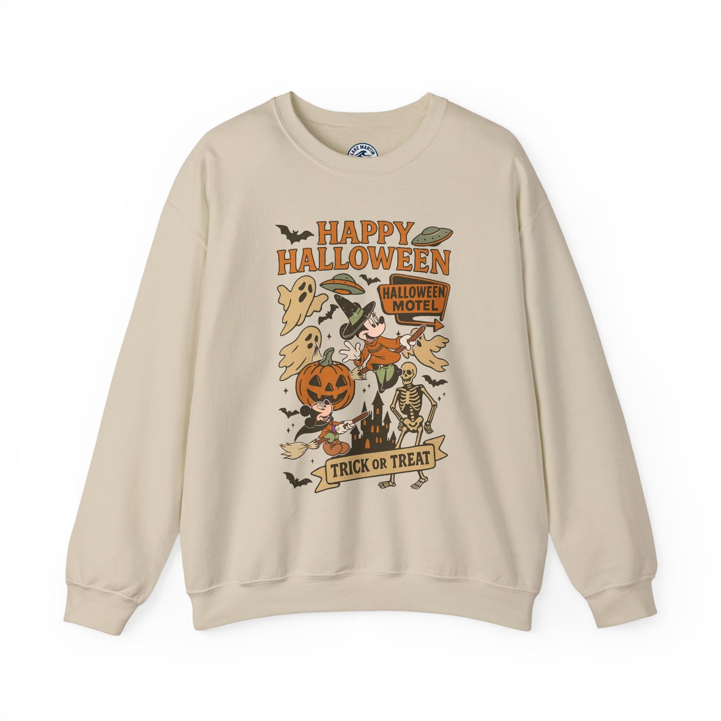A beige crewneck sweatshirt featuring a colorful retro Halloween graphic on the front with the text 'Happy Halloween' and 'Trick or Treat' along with illustrations of a pumpkin, ghosts, a skeleton, and a motel sign.