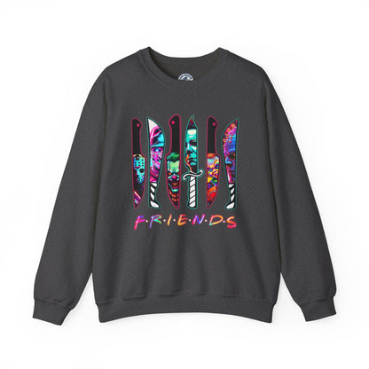 A dark gray crewneck sweatshirt featuring a graphic of six knives filled with colorful tie-dye patterns, with the word 'FRIENDS' printed below in the iconic Friends TV show font.