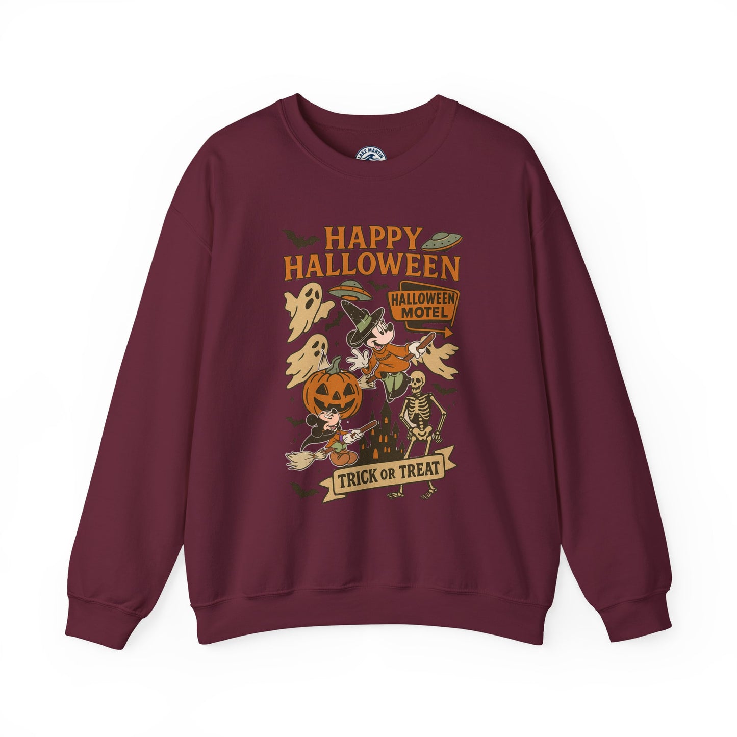A maroon crewneck sweatshirt featuring a colorful 'Happy Halloween' graphic print on the front with cartoon illustrations of a witch, pumpkin, ghosts, and a skeleton.