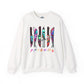 An white crewneck sweatshirt featuring a graphic of six knives with colorful tie-dye patterns and the word 'FRIENDS' printed below in a rainbow gradient, displayed on a clean white background.