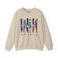 A beige crewneck sweatshirt featuring a graphic of six knives with colorful tie-dye patterns and the word 'FRIENDS' printed below in a rainbow gradient, displayed on a clean white background.