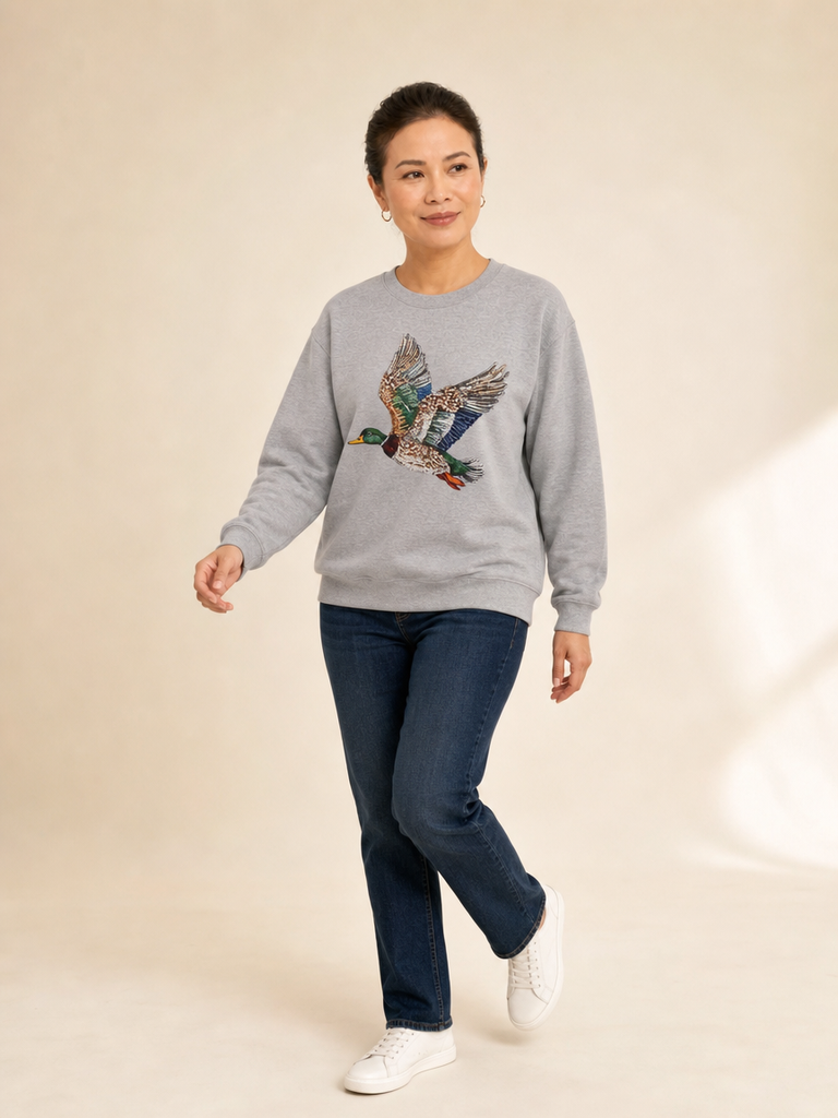 Flying mallard duck faux rhinestone design on colorful sweatshirt with relaxed fit and crewneck collar