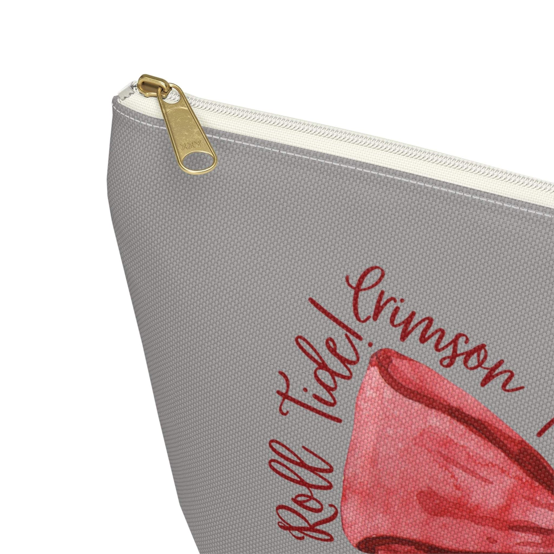 Crimson Bow Alabama script accessory pouch with vibrant red bow and gold zipper puller on muted background