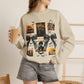 Woman wearing a beige crewneck sweatshirt featuring a vintage witch-themed Halloween collage with black bows, bats, pumpkins, and orange accents.
