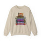 A beige crewneck sweatshirt featuring a colorful graphic print on VHS tapes with Halloween-themed characters and text including 'Halloween', 'Hocus Pocus', 'Casper', and 'Trick or Treat'.