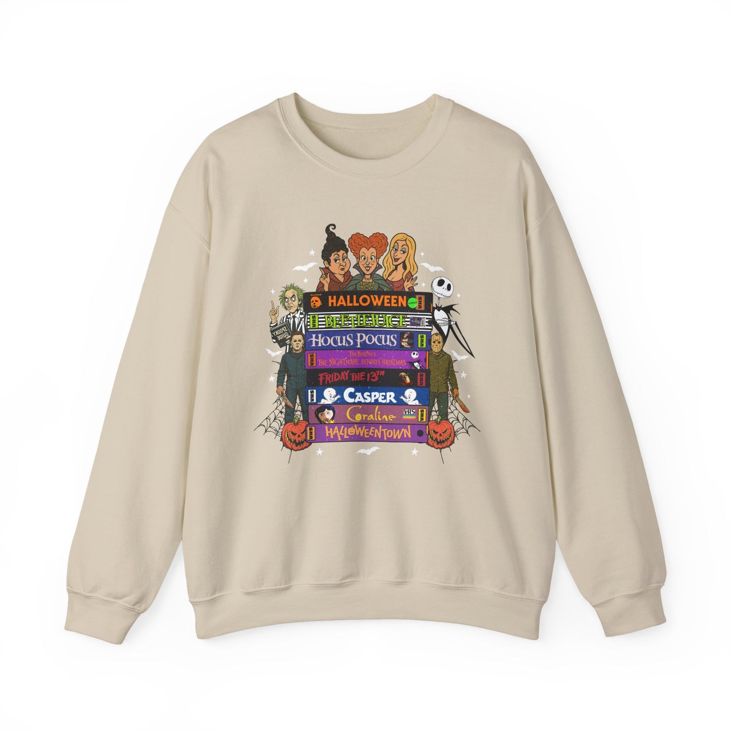A beige crewneck sweatshirt featuring a colorful graphic print on VHS tapes with Halloween-themed characters and text including 'Halloween', 'Hocus Pocus', 'Casper', and 'Trick or Treat'.