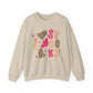 A beige crewneck sweatshirt featuring a colorful 'Spooky' graphic print with pink letters, leopard print cookies, a pink ghost, and a white ghost on a plain white background.
