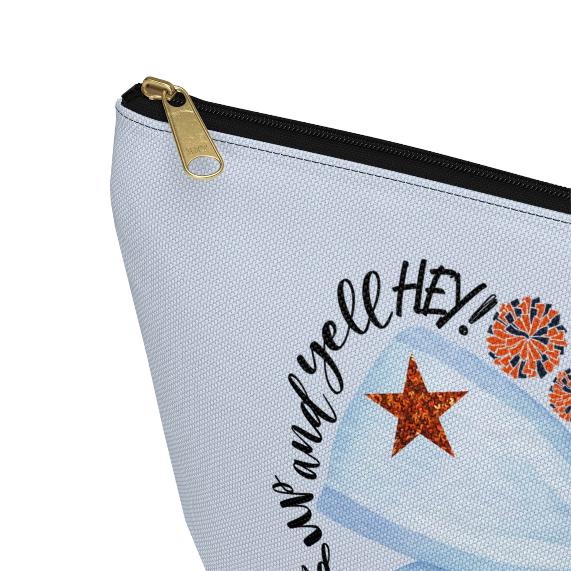 Light-blue T-bottom pouch with blue bow Auburn logo, collegiate icons, and gold zipper pull