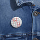 Roll Tide Pin Button with script text on grey gingham background, glossy mylar face and steel safety-pin backing