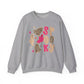 A heather gray crewneck sweatshirt featuring a 'Spooky' Halloween graphic with pink and leopard-print ghosts, stars, and textured letters on the front, displayed against a plain white background.
