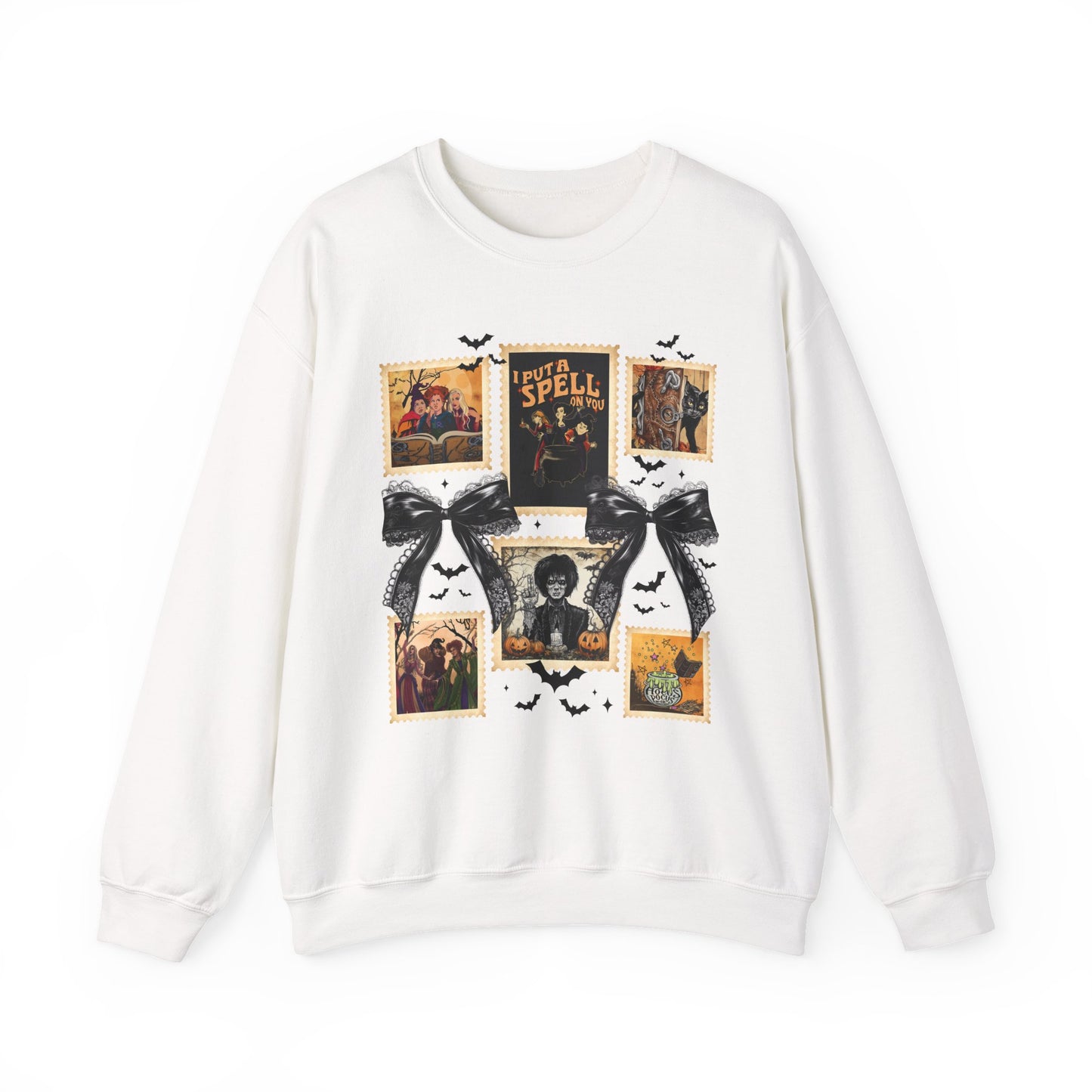  white crewneck sweatshirt featuring a vintage witch-themed Halloween collage with black bows, bats, pumpkins, and orange accents.
