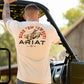 Ariat Mens Short Sleeve Shirt in cream cotton with bold red and black "Ride Em Cowboy" graphic and Ariat branding on back.