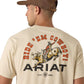 Ariat Mens Short Sleeve Shirt in beige cotton with a bold "Ride 'Em Cowboy!" graphic featuring a rodeo cowboy on a bull and Ariat branding.