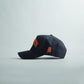 Navy blue snapback cap with curved bill, orange 3D "AUBURN" embroidery, and Alabama state silhouette, part of Auburn Alabama Legacy collection.