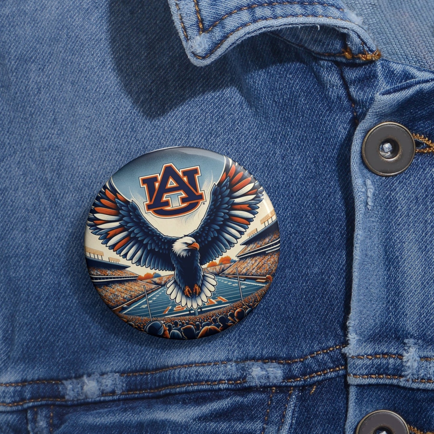 Auburn Eagle Stadium Pin featuring a glossy metal button with an orange-and-blue eagle, stadium, and Auburn logo