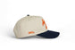 Auburn Script Hat in beige and navy cotton with orange script embroidery and a pre-curved brim