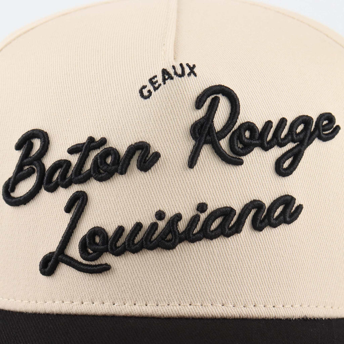 Baton Rouge beige and black trucker hat with raised embroidered script reading Baton Rouge Louisiana