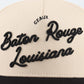Baton Rouge beige and black trucker hat with raised embroidered script reading Baton Rouge Louisiana