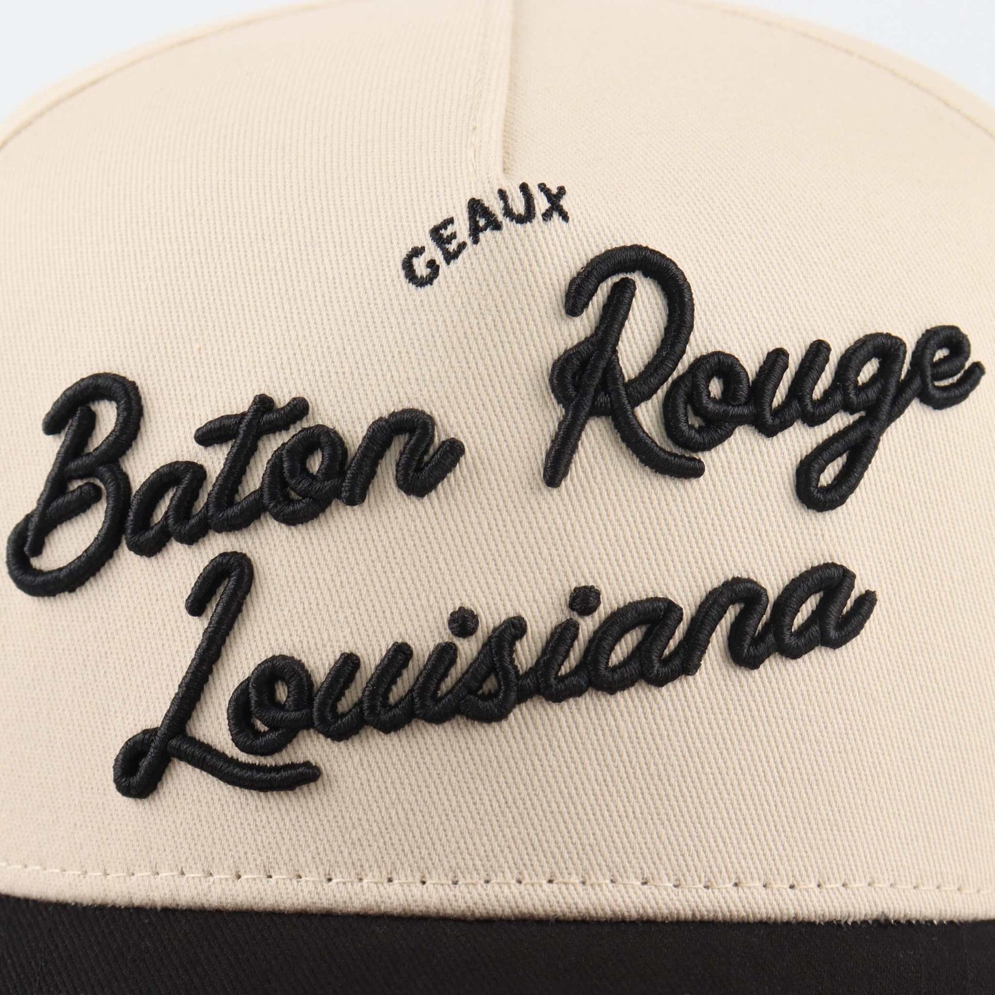 Baton Rouge beige and black trucker hat with raised embroidered script reading Baton Rouge Louisiana