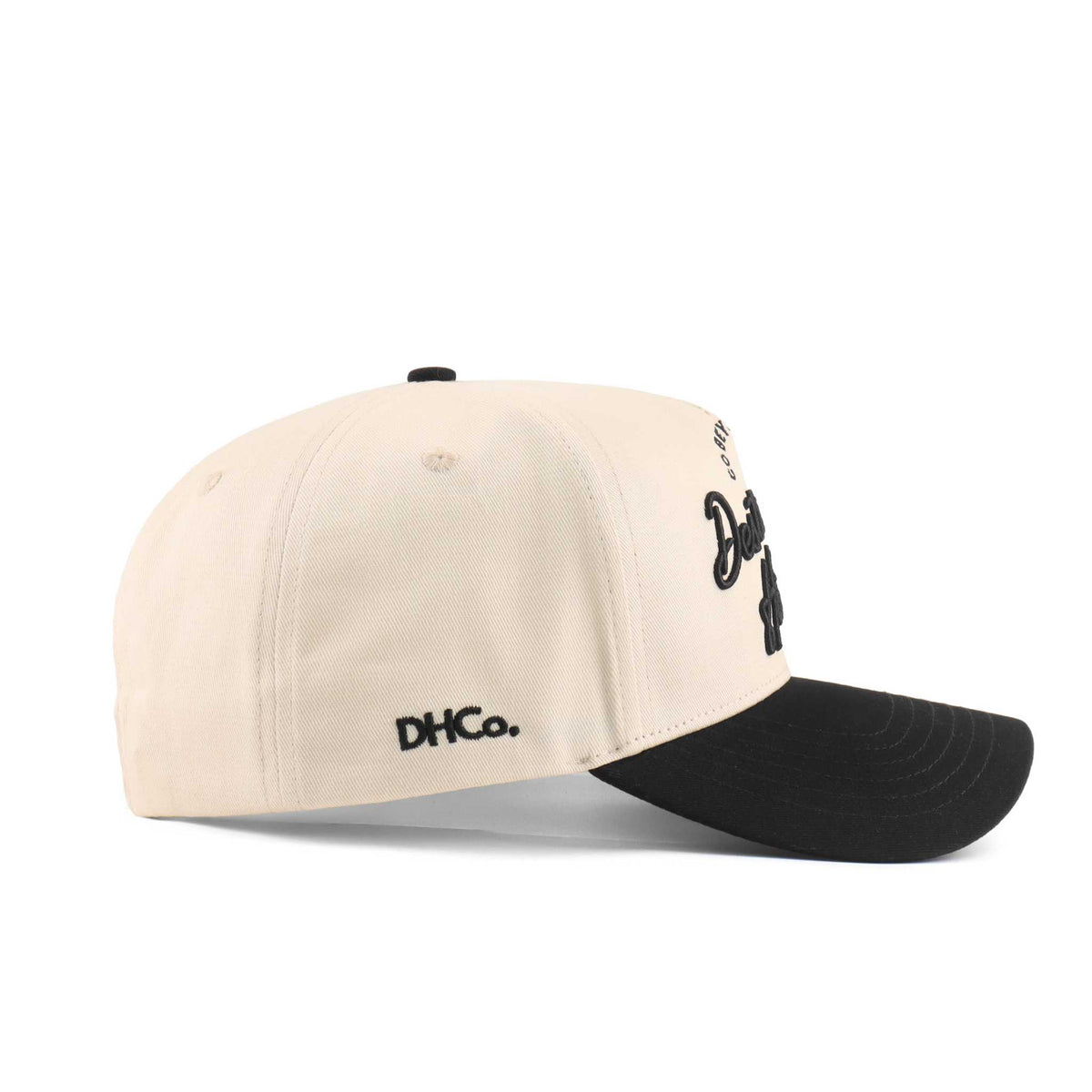 Baton Rouge script trucker hat in beige with black brim, embroidered lettering, and pre-curved bill