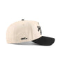 Baton Rouge script trucker hat in beige with black brim, embroidered lettering, and pre-curved bill