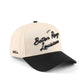 Baton Rouge script trucker hat in beige and black, featuring embroidered lettering and a pre-curved brim