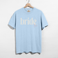 Bride Est. 2026 t-shirt in light blue cotton with white serif bride lettering and pink embroidered-style year detail