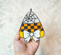 Candy Corn Freshie with orange and black checkerboard pattern, spiderweb detail, and white bow