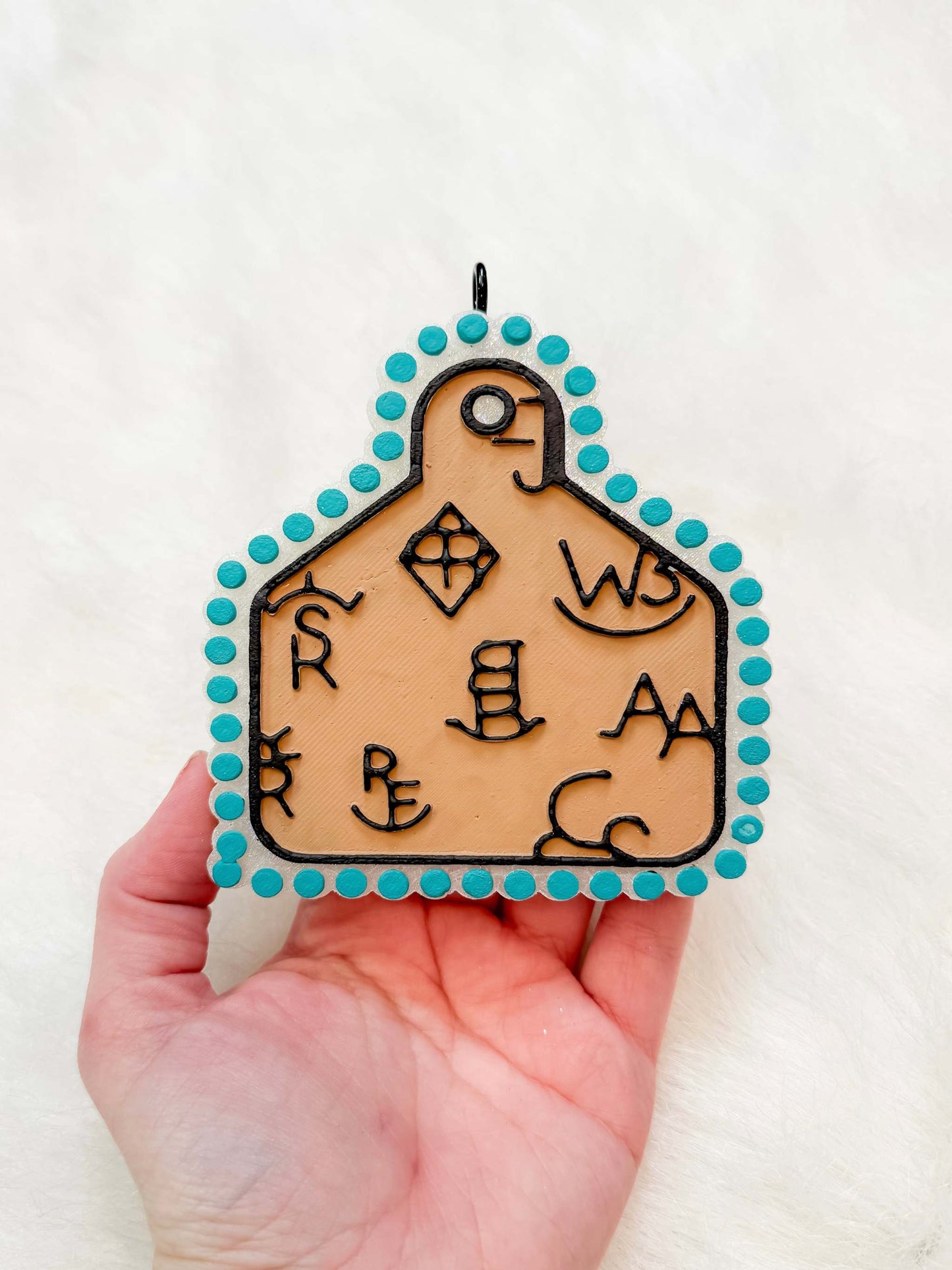 Cattle Tag Freshie in tan leather-look material with black cattle tag markings and turquoise beaded border