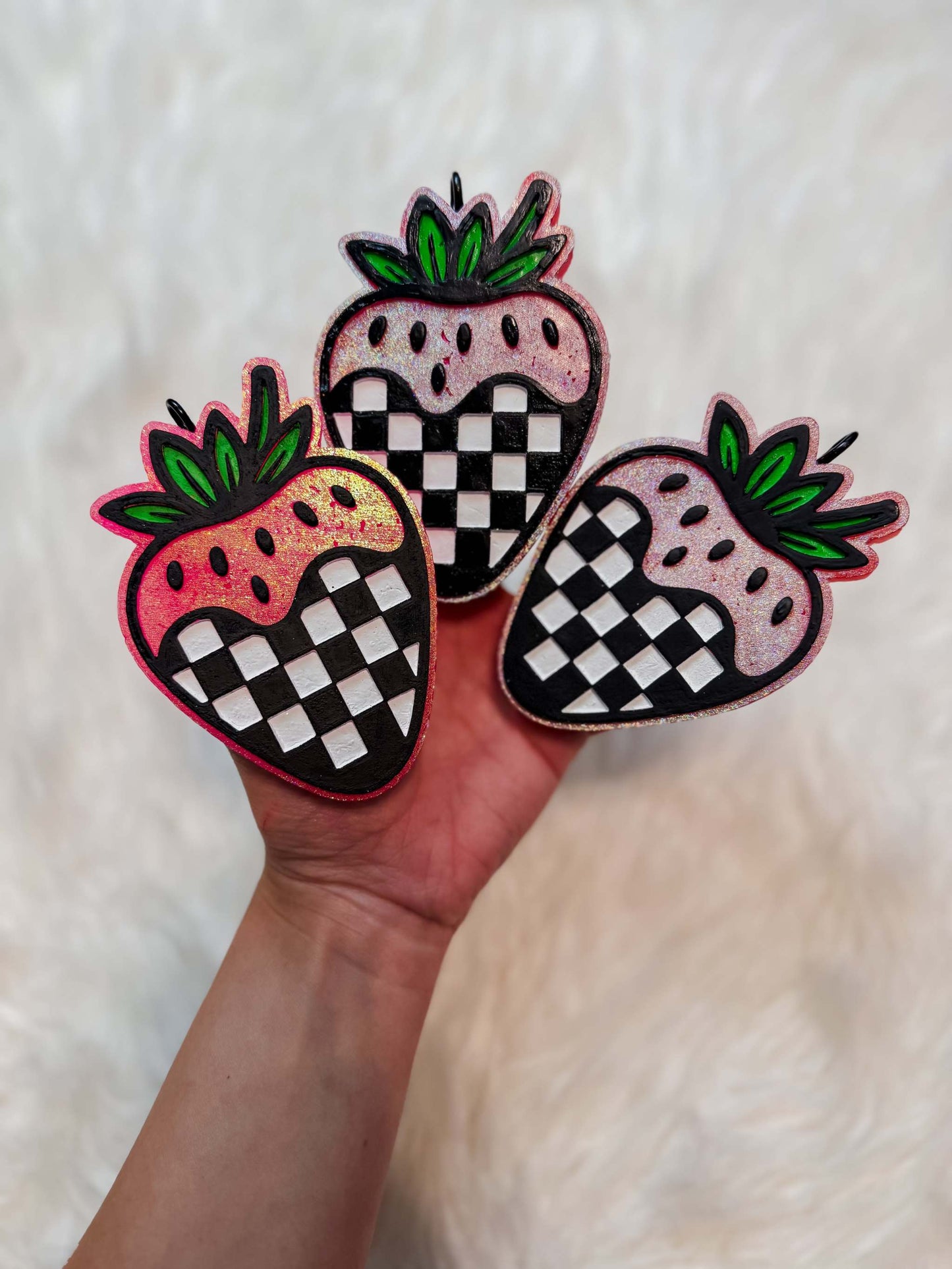 Checkered Strawberry Freshie featuring three red and pink strawberries with black-and-white checkerboard sections and green leafy tops