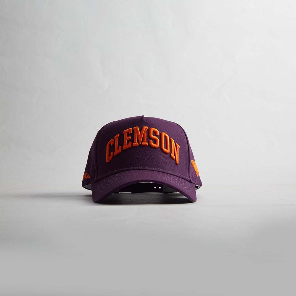 Clemson South Carolina snapback cap in purple with orange 3D embroidered lettering and curved bill