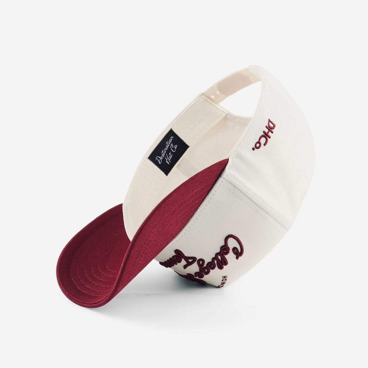 College Station Script Hat in beige and maroon with embroidered script, mesh panels, and a pre-curved brim