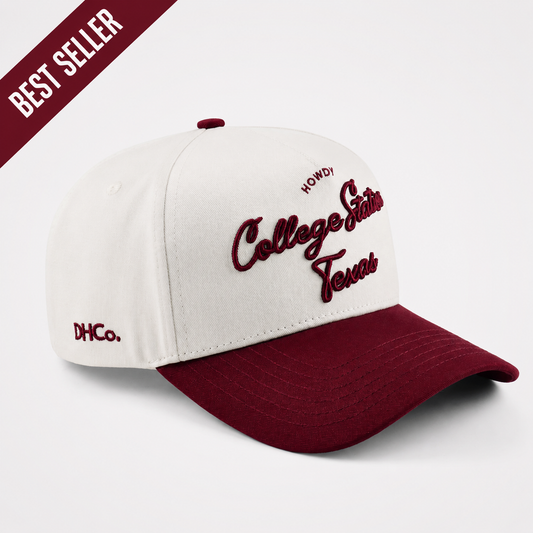 College Station Script Hat in cream and maroon cotton, featuring embroidered script lettering and a pre-curved brim