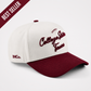College Station Script Hat in cream and maroon cotton, featuring embroidered script lettering and a pre-curved brim