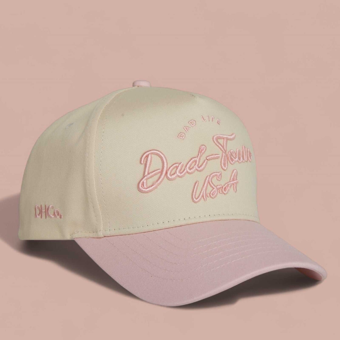 Dad-Town Script Hat in beige and light pink, featuring embroidered script lettering and a pre-curved brim