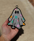 Daisy Ghost Freshie in glittery silver with black outline, oval eyes, and colorful daisy flowers