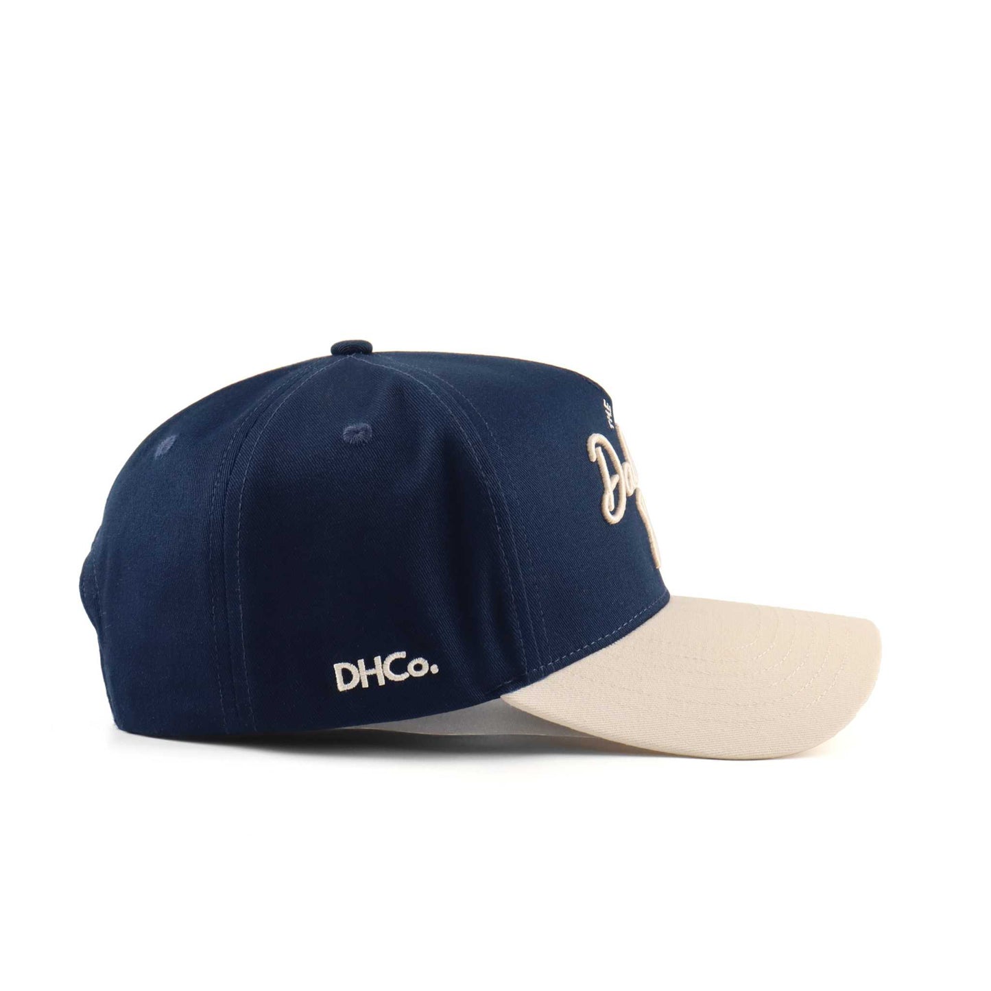 Dallas Script Hat in navy and beige with embroidered script, curved brim, and fitted six-panel design