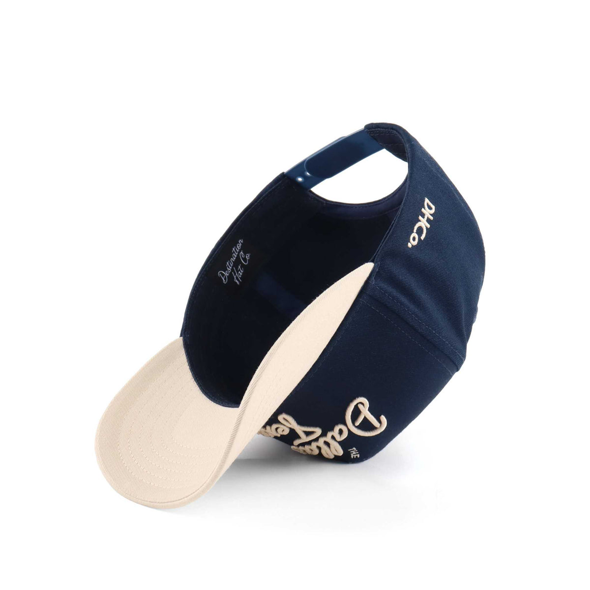 Dallas Script Hat in navy and beige cotton with embroidered script lettering and a pre-curved brim