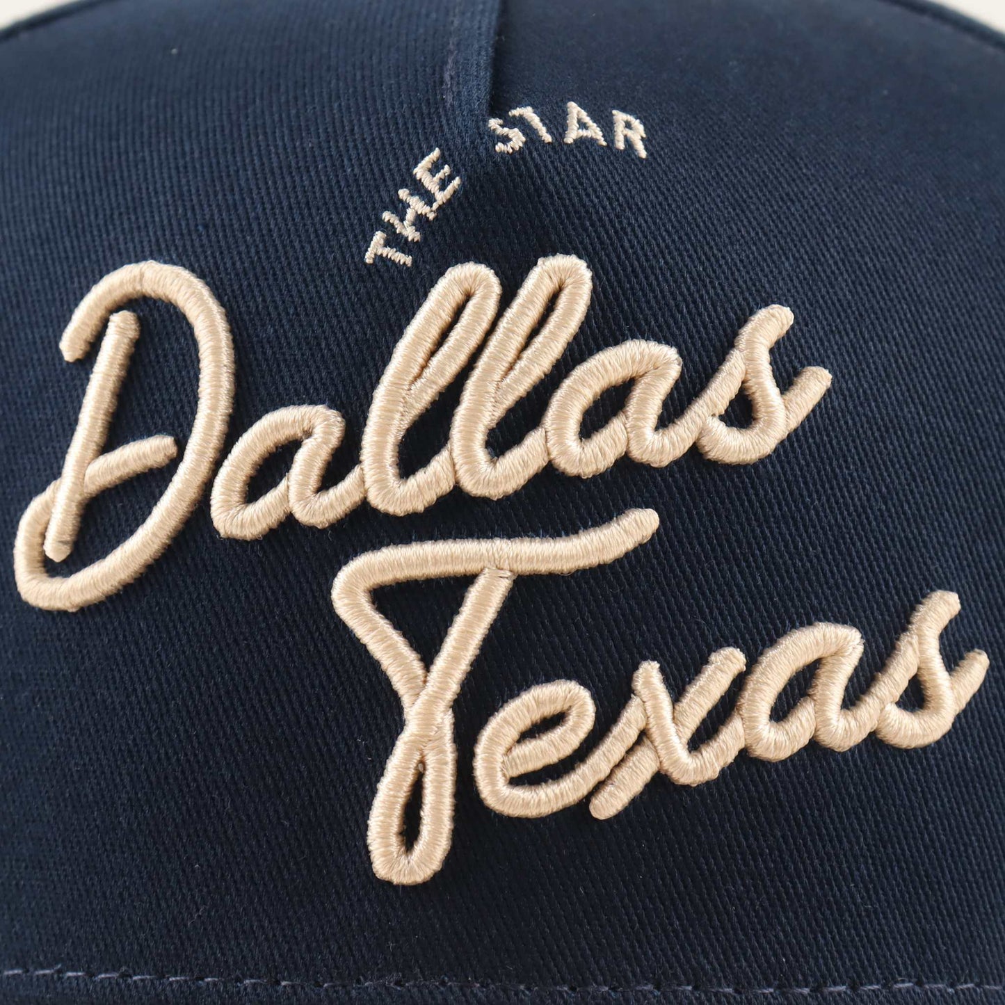 Dallas Script Hat in navy fabric with raised beige Dallas Texas script embroidery and a star detail
