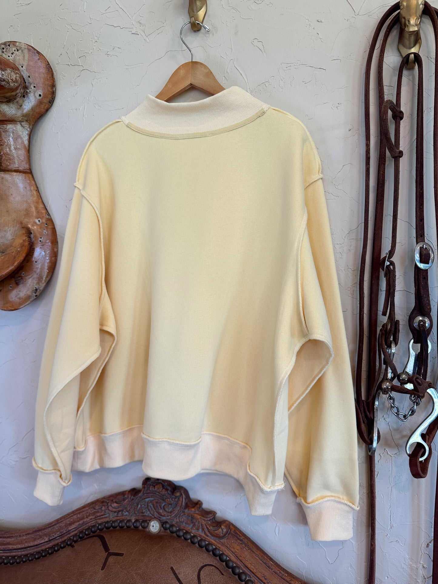 Dillydally Mock Neck Sweatshirt in soft butter yellow with a cozy cotton-polyester blend and ribbed cuffs and hem.